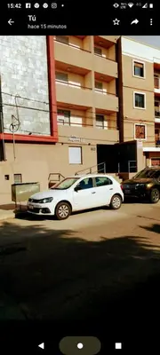 a white car parked in front of a building at MM Apart in Río Cuarto