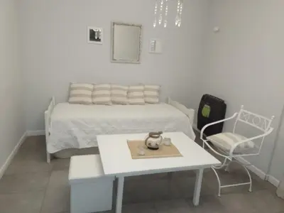 a bedroom with a bed and a table and a chair at MM Apart in Río Cuarto
