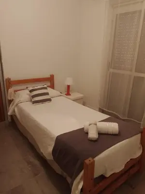 a bedroom with a bed with two towels on it at MM Apart in Río Cuarto