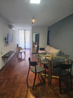 a living room with a couch and a table and chairs at LOCADOR Nueva Cordoba 3C in Cordoba