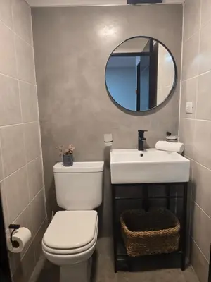a bathroom with a toilet and a sink and a mirror at LOCADOR Nueva Cordoba 3C in Cordoba