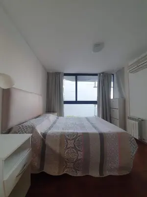 a bedroom with a bed and a large window at Nueva Cordoba 3D in Cordoba