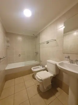 a bathroom with a toilet and a sink and a tub at Nueva Cordoba 3D in Cordoba
