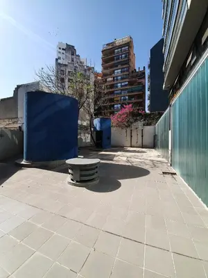 a bench sitting on a sidewalk next to a building at Nueva Cordoba 3D in Cordoba
