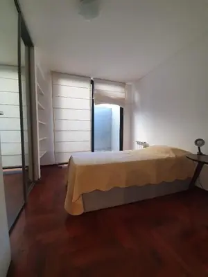 a bedroom with a bed and a large window at Nueva Cordoba 3D in Cordoba