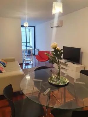 a living room with a glass table with flowers on it at Nueva Cordoba 3D in Cordoba