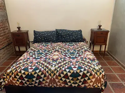 a bedroom with a bed and two night stands at LO DE CAPRETTA in Almafuerte