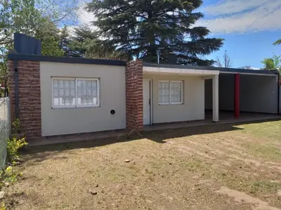 a small house with a brick building at Cabaña Los Pajaritos in Villa Rumipal