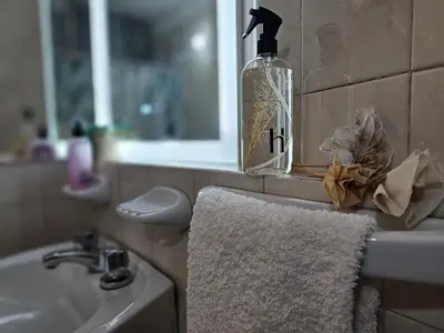 a bathroom with a sink and a soap dispenser and a towel at Milca Celeste Nueva Córdoba in Cordoba