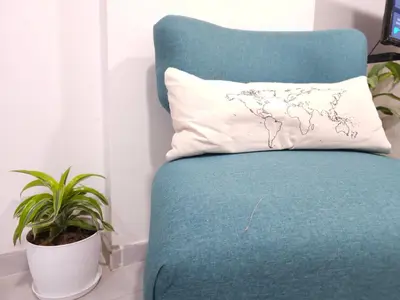 a blue chair with a pillow and a plant at Milca Celeste Nueva Córdoba in Cordoba