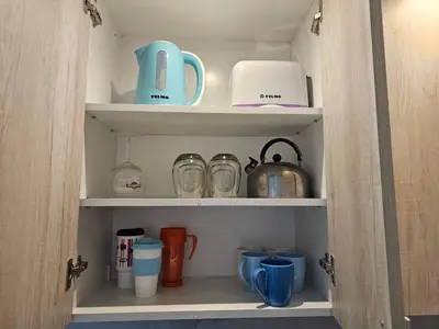 a cupboard with dishes and utensils in it at Milca Celeste Nueva Córdoba in Cordoba