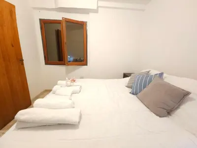 a large white bed with towels and a mirror at Milca Celeste Nueva Córdoba in Cordoba