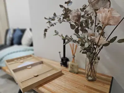 a wooden table with a vase with flowers on it at Milca Celeste Nueva Córdoba in Cordoba