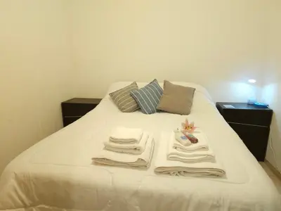 a bed with towels and pillows on it at Milca Celeste Nueva Córdoba in Cordoba
