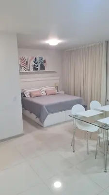 a bedroom with a bed and a table and chairs at II Opera Towers Villa Carlos Paz in Villa Carlos Paz