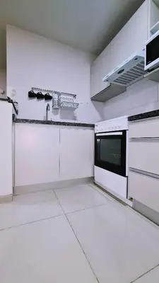 a white kitchen with white counters and appliances at II Opera Towers Villa Carlos Paz in Villa Carlos Paz