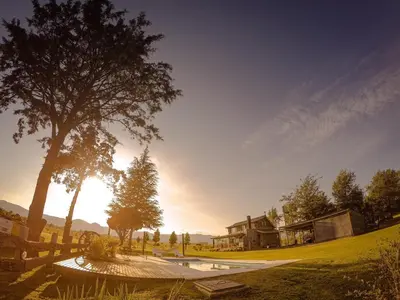 a skate park with a tree and a building at Cabañas LA IRMA in Villa Ciudad Parque