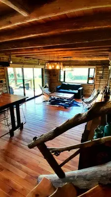 a living room with a couch and a table at Cabañas LA IRMA in Villa Ciudad Parque