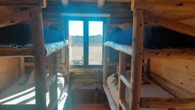 a room with three bunk beds in a cabin at Cabañas LA IRMA in Villa Ciudad Parque