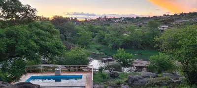 a swimming pool with a view of a river at Cabañas Sol Marina in Villa Parque Siquiman