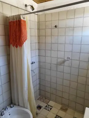 a bathroom with a shower and a toilet at Cabañas Sol Marina in Villa Parque Siquiman