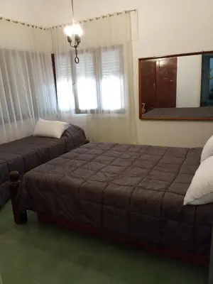 a bedroom with two beds and a window at casa de marta a 50 mts del centro in Villa Carlos Paz