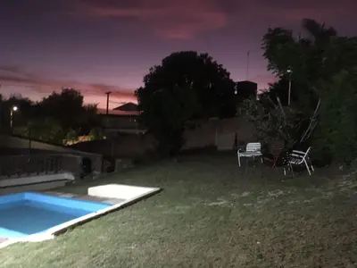 a backyard with a swimming pool at night at casa de marta a 50 mts del centro in Villa Carlos Paz