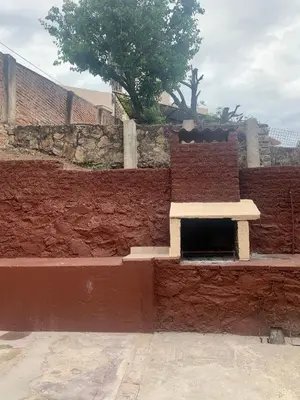 a brick wall with a bench on top of it at casa de marta a 50 mts del centro in Villa Carlos Paz