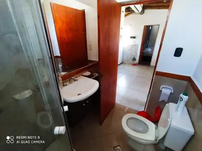 a small bathroom with a toilet and a sink at Ohana in Cordoba