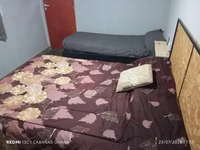 a bed with a purple blanket with flowers on it at Ohana in Cordoba