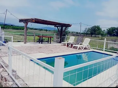 a swimming pool with two chairs and a picnic table at Ohana in Cordoba