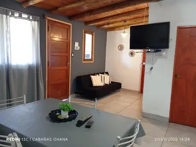 a living room with a table and a television at Ohana in Cordoba