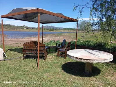 a table and two chairs under an umbrella at Ohana in Cordoba