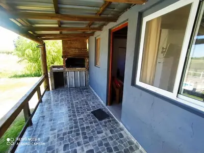 a porch of a house with a brick floor at Ohana in Cordoba