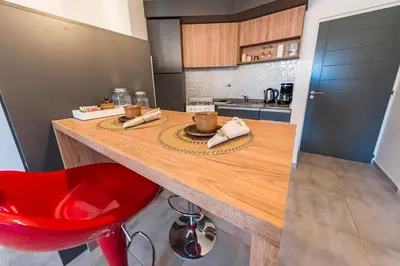 a kitchen with a wooden counter and a red chair at Viaggiato Duarte Quirós in Cordoba