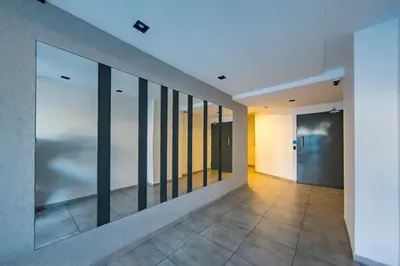 an empty hallway with a row of mirrors on the wall at Viaggiato Duarte Quirós in Cordoba