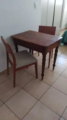 a wooden table and two chairs and a wooden table and a table at Monoambiente para 2 personas con baño privado in Cordoba