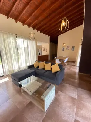 a living room with a blue couch and a table at Andelka-Chumamaya Merlo San Luis in Merlo