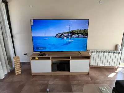 a flat screen tv sitting on a stand in a living room at Andelka-Chumamaya Merlo San Luis in Merlo