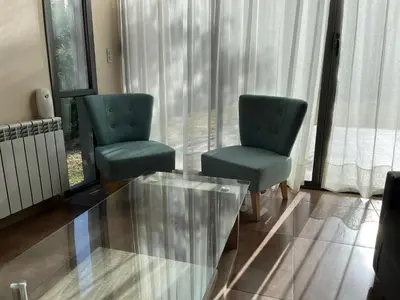 two chairs and a glass table in a living room at Andelka-Chumamaya Merlo San Luis in Merlo