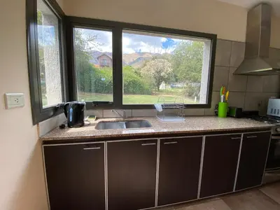 a kitchen with a sink and a large window at Andelka-Chumamaya Merlo San Luis in Merlo