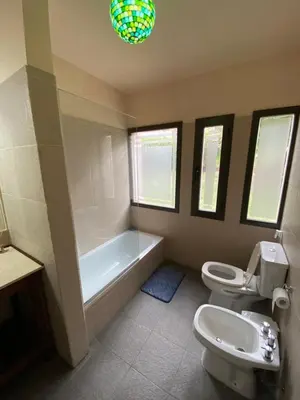 a bathroom with two toilets and a tub and a sink at Andelka-Chumamaya Merlo San Luis in Merlo