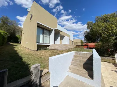a house with a staircase in front of it at Andelka-Chumamaya Merlo San Luis in Merlo