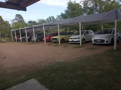 a row of cars parked under a tent at Hostería Reserva Serrana in Mina Clavero
