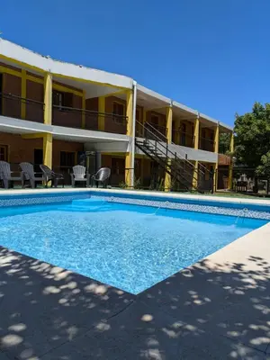 a swimming pool in front of a building at Hostería Reserva Serrana in Mina Clavero