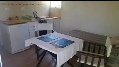 a small kitchen with a table and a counter top at El Encuentro in Tanti
