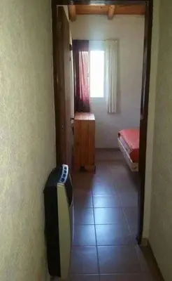 a room with a room with a bed and a television at El Encuentro in Tanti