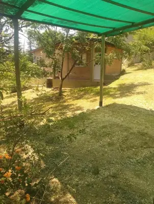 a green tent in a yard with a house at El Encuentro in Tanti