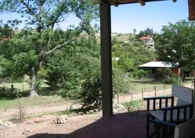 a porch with a bench and a view of a field at El Encuentro in Tanti
