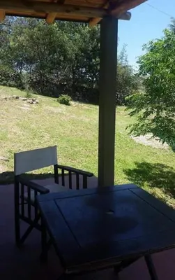 a table and two chairs sitting under a gazebo at El Encuentro in Tanti